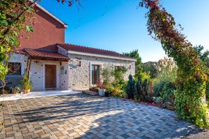 a house with a brick driveway in front of it at Villa Pamaroka in Šibenik