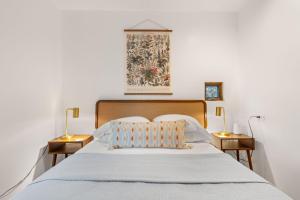 a bedroom with a large bed with two night stands at Casa de Flechas in Santa Fe NM in Santa Fe