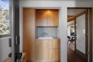 a kitchen with wooden cabinets and a sink at Casa de Flechas in Santa Fe NM in Santa Fe +50 photos