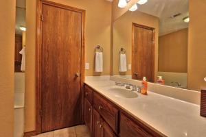 a bathroom with a sink and a large mirror at Honky Tonk Getaway in Driftwood +18 photos