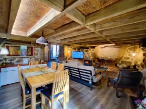 a dining room with a table and chairs and a fireplace at Castrum Houses - Casa da Curveirinha - Jacuzzi in Melgaço