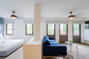a bedroom with a blue couch and a bed at Wonderful Loft in Casco Viejo in Panama City