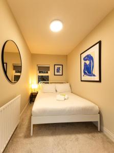 a bedroom with a bed and a mirror at The Annadale - Luxury 3 bd House - Gold Short Term Stays in Belfast