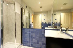a bathroom with two sinks and a shower at The Annadale - Luxury 3 bd House - Gold Short Term Stays in Belfast +41 photos