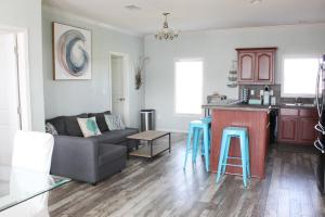 a kitchen and living room with a couch and a table at Beach Getaway at 2 Pelicans Walk to the Water in Crystal Beach