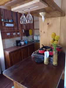 a kitchen with a wooden counter top with pots and pans at La cabaña de Eugenio in Convento +17 photos