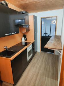 a kitchen with a sink and a counter top at Joli appartement à Mont-Louis in Mont-Louis +2 photos