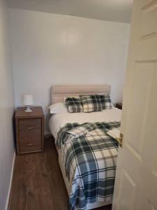 a small bedroom with a bed and a night stand at Kilvington Crib in Sheffield