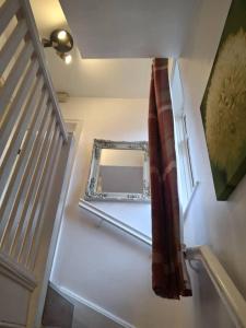 a stairway with a mirror on the floor next to a staircase at Kilvington Crib in Sheffield