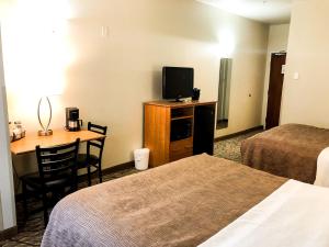 Postel nebo postele na pokoji v ubytování Aspen Hotel