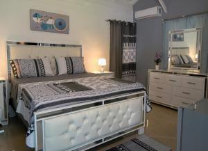 a bedroom with a large bed with a mirror and a dresser at Casa Ballenas3 SF in Las Terrenas