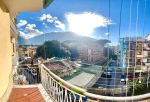 a view from a balcony of a city with a tennis court at Home Jocy Spacious 3 Bed rooms Apartment with private Parking Ideal for Groups in Castellammare di Stabia
