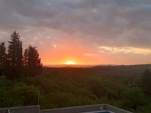 a sunset from the balcony of a house at cabañas Saona in Molinari