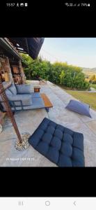 a picture of a patio with blue pillows and a table at MareBob in Peršaves +4 photos
