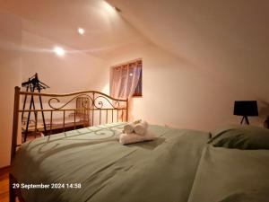 a stuffed animal is sitting on a bed at MareBob in Peršaves