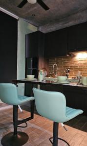 a kitchen with two chairs and a kitchen counter at Kasa Nikte Tulum in Tulum