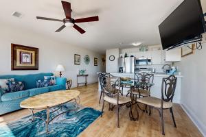 a living room with a blue couch and a table at Veranda 101 in Fort Walton Beach