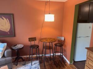 a kitchen with a table and stools and a refrigerator at Treehouse in Rainer Beach in Seattle +4 photos