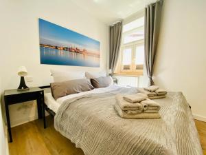 a bedroom with a bed with towels on it at HafenCity App No 4 in Stralsund