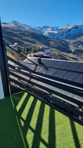 a view of a building with grass and a train at NIMBO Apartment in Sierra Nevada