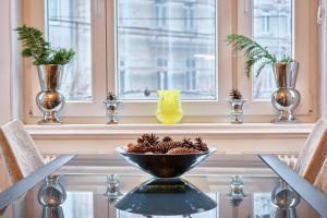 a bowl of pine cones on a table in front of a window at Slow Living I Schönbrunn und Park nähe I Penzing Bahnhof in Vienna