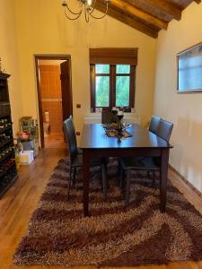 a dining room with a table and chairs on a rug at MHome AGIOS ATHANASIOS in Palaios Agios Athanasios +8 photos