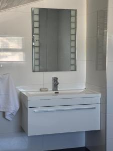 a white bathroom with a sink and a mirror at Heaven in Cape Town +40 photos