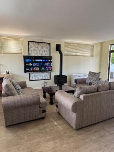 a living room with two couches and a stove at Heaven in Cape Town