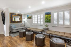a living room with a couch and chairs and windows at Best Western Dry Creek Inn in Healdsburg