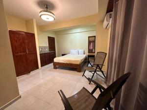 En eller flere senger på et rom på Hotel Turístico Marian