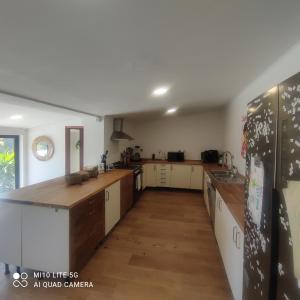 a large kitchen with wooden counter tops and cabinets at Guincho Rural Villa in Cascais
