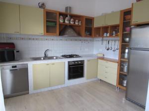 a kitchen with a sink and a refrigerator at La casa di Lori in San Benedetto del Tronto