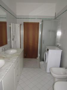 a bathroom with a toilet and a sink at La casa di Lori in San Benedetto del Tronto +17 photos