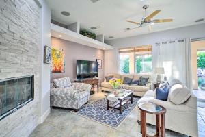 a living room with a couch and a fireplace at Spacious Palm Desert Home with Patio, Pool and Grill in Palm Desert