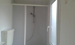 a shower in a bathroom next to a toilet at Mobilhome Angel in Cavallino-Treporti