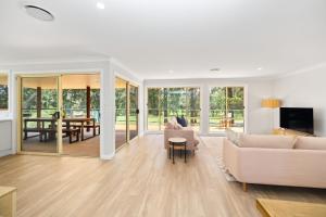 a living room with a couch and a table at Beaches n Birdies in Mollymook