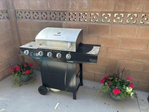 a grill sitting on a table next to a brick wall at Townhome Modern in Pueblo