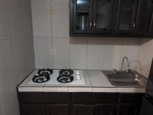 a kitchen counter with a stove and a sink at Condominio 1 in San Felipe