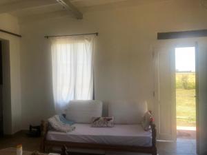 a room with a bed and a window and a door at A Morriña in Santa Lucía