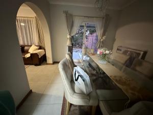 a living room with a glass table and a couch at The Aurum guesthouse in Durban