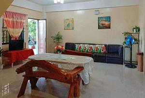 a living room with a table and a couch at RedDoorz @ Mary Land Transient Alaminos Pangasinan in Alaminos +15 photos