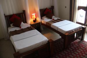 Rúm í herbergi á Al-Minar Hotel