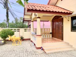 a house with a statue of a deer in front of it at Bangtao15 Private House in Ban Lum Fuang