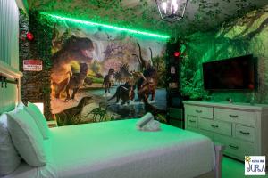 a bedroom with a mural of dinosaurs on the wall at Deluxe themed private ROOMS - Ensuite Bath & Pool Access by Casa Da Jura in Kissimmee