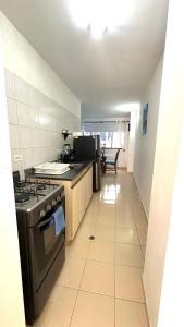 a kitchen with a stove and a counter top at María Hosting 304 in Santa Marta