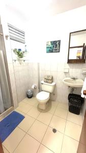 a bathroom with a toilet and a sink at María Hosting 304 in Santa Marta