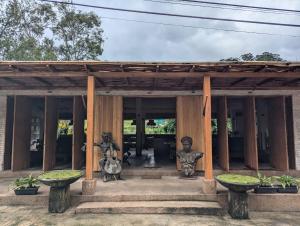 a building with two statues in front of it at The Green Door in Ella