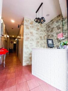 a restaurant with a counter and a red table at The Hotel Tudor Inn in Cameron Highlands