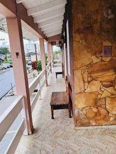 a building with a bench and a stone wall at Della Giustina Residence Comforto Aparthotel - Aconchegante, Lindo, Moderno, Renovado entre Abba Pai Church e Centro in Criciúma