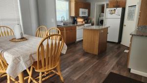 a kitchen with a table and chairs and a refrigerator at El Paraiso at Island Park in Island Park
